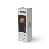 A standing, white packaging box for a 20ml bottle of essential oil with a photographic image of a yellow rose on its front and the word "EARTH" above it, and "homework" below.