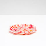 A side view of a NiMi Projects’ Buoy recycled plastic polygon-shaped soap dish in mottled white and red, made of marine waste plastic collected from the shores of Japan.Edit alt text