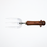 A stainless steel gardening fork with walnut wood handle and leather hanging strap, made by Asano Mokkousho in Japan's famous metalworking district Tsubame-Sanjo, and sold at NiMi Projects UK.