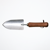 Asano Mokkousho's stainless steel trowel, with a walnut wood handle and leather hanging strap, made in Japan's Tsubame-Sanjo metalworking district in Japan and available at NiMi Projects UK.