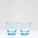 A pair of blue Spash stackable glass tumblers, made in Japan by Toyo Sasaki Glass and available at NiMi Projects UK.