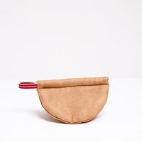 A brown Ban Inoue pot holder oven mitt. The mitt is lightly padded muslin, oval and folded at the centre to appear semicircle and features a braided hanging cord on the left corner. Made in Japan and on show at NiMi Projects UK.