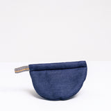 A navy blue Ban Inoue pot holder oven mitt. The mitt is lightly padded muslin, oval and folded at the centre to appear semicircle and features a braided hanging cord on the left corner. Made in Japan and on show at NiMi Projects UK.