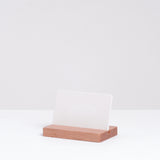 Detail of a Ceramic Japan white stone porcelain aroma card diffuse  propped on a wooden stand.  Made in Japan and on display at NiMi Projects.,