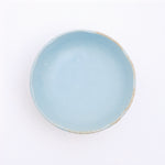 Top view of a Mino-yaki Japanese porcelain plate with fluted edge in sky blue. On show at NiMi Projects UK.