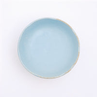 Top view of a Mino-yaki Japanese porcelain plate with fluted edge in sky blue. On show at NiMi Projects UK.
