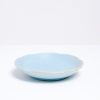 A Mino-yaki Japanese porcelain plate with fluted edge in sky blue. On show at NiMi Projects UK.