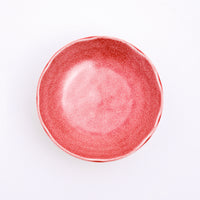 A top view of a Mino-yaki Japanese porcelain plate with fluted edge in speckled red. On show at NiMi Projects UK.