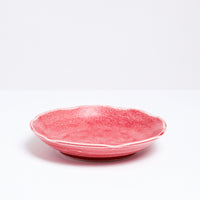 A Mino-yaki Japanese porcelain plate with fluted edge in speckled red. On show at NiMi Projects UK.