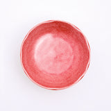 A top view of a Mino-yaki Japanese porcelain plate with fluted edge in speckled red. On show at NiMi Projects UK.