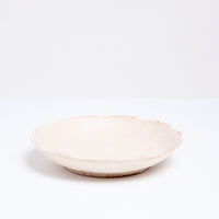 A Mino-yaki Japanese porcelain plate with fluted edge in a creamy off-white. On show at NiMi Projects UK.
