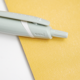 Detail image of a mint green Uniball Jetstream pen, showing its retractable push top and clip. Available at NiMi Projects UK