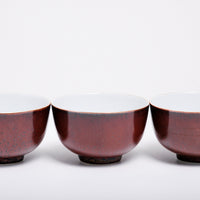 Three vintage mahogany brown Japanese tea cups made of extra-light Arita porcelain, rich brown glaze and subtly speckled in black.