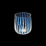 A short, tumbler glass featuring a rounded base and a pattern of opalescent and clear lines. Made in Japan by Hirota Glass and Moheim, and available at NiMi Projects UK.
