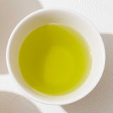 View from above of  a white porcelain cup filled with vibrant Iro Kabusecha Japanese green tea. ©AWAIDO