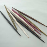 A bundle of Style of Japan double-end tapered ryokuchi style wooden hashi chopsticks, showing their different colours  — red, green, black, natural and brown.