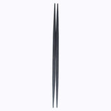 A pair of black Style of Japan ryokuchi double-end tapered wooden chopsticks(hashi)  on a white background. Available at NiMi Projects UK.