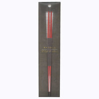 A pair of Style of Japan  red, Hashi wooden chopsticks in black paper packaging.