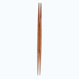 A pair of brown double-end tapered ryokuchi wooden hashi chopsticks made by Style of Japan, on a white background. Available at NiMi Projects UK.