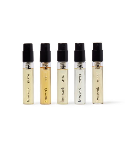 Five small perfume bottles labeled 'Earth', 'Fire', 'Metal', 'Water', and 'Wood' by 'homework' on a white background.