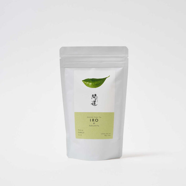 A white pouch of Awaido Japanese green tea leaves. The pouch has a rectangle label with a green illustration of a tea leaf and the name of the tea in Japanese kanji. Below the kanji is a green section of the label with the name in English: Iro. Image ©AWAIDO