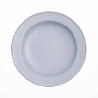 A duck-egg blue round Kihon no Utsuwa Japanese porcelain, rimmed side dish, with lightly curved base. Available at NiMi Projects UK.
