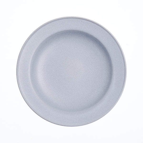 A duck-egg blue round Kihon no Utsuwa Japanese porcelain, rimmed side dish, with lightly curved base. Available at NiMi Projects UK.
