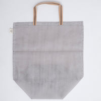 A large navy blue gause Vegetable tote bag, made in Japan by Ban Inoue using traditional mosquito net weaving techniques. The bag has a folded and stitched base for support and short top handles. On show at NiMi Projects UK.