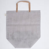 A large navy blue gause Vegetable tote bag, made in Japan by Ban Inoue using traditional mosquito net weaving techniques. The bag has a folded and stitched base for support and short top handles. On show at NiMi Projects UK.