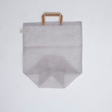 A medium, transparent silvery grey muslin Vegetable tote bag, made in Japan by Ban Inoue using traditional mosquito net weaving techniques. The bag has a folded and stitched base for support and short top handles. On show at NiMi Projects UK.