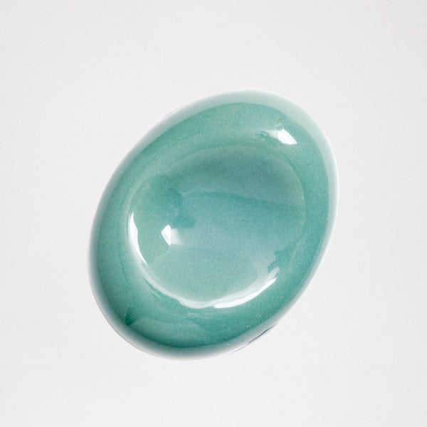An ariel view of a green sora-mame bean-shaped Japanese, Mino-yaki ceramic hashioki chopstick rest. Available at NiMi Projects.