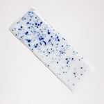 An ariel view of a white and blue speckled Japanese pillow-shaped, Mino-yaki ceramic hashioki chopstick rest. Available at NiMi Projects UK.