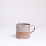 An earthenware mug half-dipped from the top in a glossy grey glaze. Made in Japan by Angle ceramics and pictured at NiMi Projects UK.