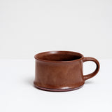 An extra wide, flat-based mug in a rich brown, mottled satin glaze on show at NiMi Projects UK and hand made by Angle in Japan.