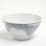 The Ito Tsumugi Japanese white porcelain mino-yaki ramen and noodle bowl, featuring a pattern of criss crossed lines, designed after a Japanese weaving technique. On show at NiMi Projects UK.
