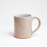 Side view of a large off-white glazed ceramic mug with a handle at an unusual angle. Hand made by Angle in Japan and available at NiMi Projects UK.