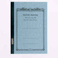 A pale blue Apica note book, showing an arabesque border printed in black with the words "Notebook" and "Most advanced quality Gives best writing features." Its spine is bound in black with a gold CD11 stamp. Made in Japan and available at NiMi Projects UK.