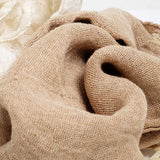 A close-up of draped clove brown Ban Inoue, organic cotton muslin kitchen cloth, showing its woven texture. On show at Nimi Projects UK.
