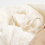 Close-up of Ban Inoue, organic cotton muslin kitchen cloth  in natural white tone, showing a textured weave. Available at NiMi Projects UK.

