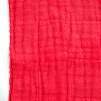 Detail of the textured red Japanese muslin  fabric of a Ban Inoue dishcloth.