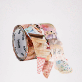 A gif animation of a double roll of Bande Japanese washi tape ice cream and cone stickers. The roll has two rows — one featuring individual stickers of ice cream cones and another of  individual ice cream scoops. The animation shows a cone rotating off the sticker roll and landing to the right, followed by a doubles scoop of ice cream landing on top. Available at NiMi Projects UK. 