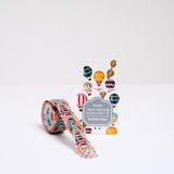 A roll of Japanese washi paper tape, featuring individual designs of hot air ballloons. Pictured with its packaging and available at NiMi Projects UK.