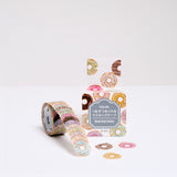 A roll of Japanese washi tape donut stickers and its packaging, featuring designs of doughnuts. Available at NiMi Projects UK.