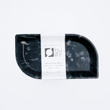 An environmentally conscious recycled ocean plastic waste black tray, shaped as a small leaf. Made and designed by Buoy in Japan and on show at NiMi Projects UK.