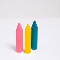 A group of  three retro-colored, triangular, Sakura Coupy dry highlighter crayons at  NiMi Projects UK in pink, yellow and turquoise.