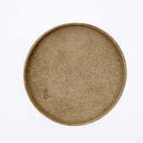 Ariel view of a large round, beige Rhythmos, up-cycled, skived split leather tray. The tray has been molded into shape by Japanese leather artisans and is available at NiMi Projects UK.