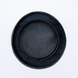 Ariel view of a small, round, deep navy blue, up-cycled, skived split leather tray on top of a larger version. The trays have been molded into shape by Japanese leather artisans Rhythmos and is available at NiMi Projects UK.