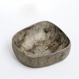 A rectangular Chinaberry wood, hand crafted bowl showing the texture of hand-chisel carving and finished in urushi silvery grey lacquer and a dusting of shimmery tin powder. Made by Solmu Puut in Japan from wood collected in Yakushima and on show at NiMi Projects UK.