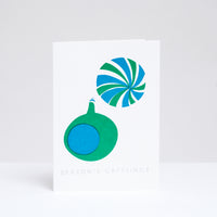 A Takako Copeland Christmas card, featuring two baubles hand-printed in green and blue.