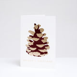 Takako Copeland's Christmas Gold Pine Cone greeting card, featuring a letterpress-printed aubergine-coloured pine cone with gold highlights and the words “Season’s Greetings” in gold foil.
